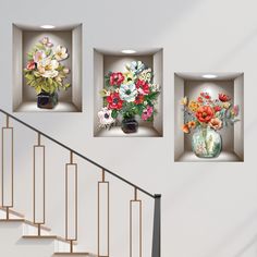 three vases filled with flowers sitting on top of a set of stairs