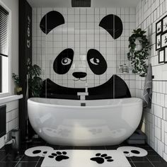 a panda bear bathroom with black and white tiles on the walls, floor and bathtub