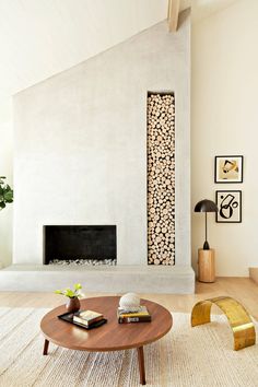 a living room with a fire place and a large painting on the wall behind it