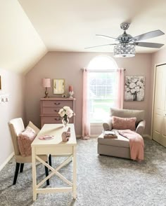 a living room filled with furniture and a window covered in pink draping next to a white table