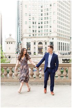 an engaged couple holding hands and walking in the city