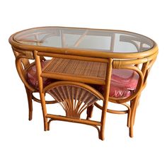 a table with a glass top and wicker furniture on it's sides,