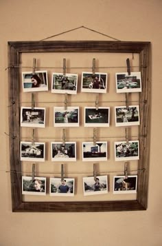 a wooden frame hanging on a wall with photos pinned to it