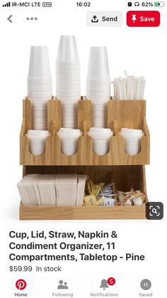 cups and napkins are stacked on a wooden holder