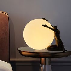 a lamp sitting on top of a table next to a chair