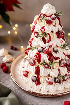 a christmas tree made out of meringue and strawberries on a platter