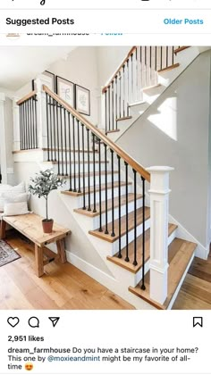 a living room filled with furniture and a stair case next to a wooden table on top of a hard wood floor