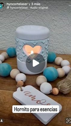 an image of a candle and some beads on a table with a tag that says horrito para esencias