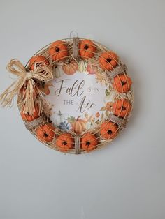 an orange wreath that says fall is in the air