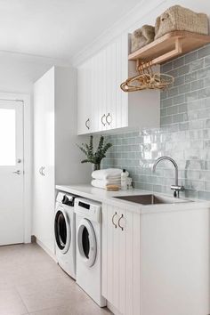 a washer and dryer in a white laundry room