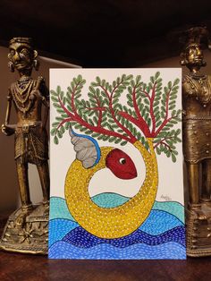 a card with an image of a tree on it next to two figurines