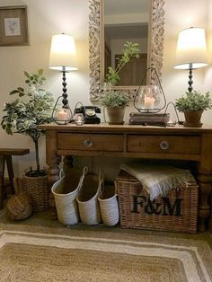 a wooden table topped with baskets filled with flowers and plants next to a mirror on top of a wall