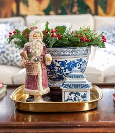 a christmas decoration is sitting on a tray in front of a couch and coffee table