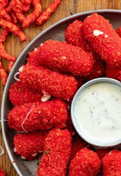 a plate full of fried food with dipping sauce