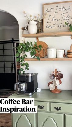 a kitchen with green cupboards and shelves filled with coffee pots, mugs and other items