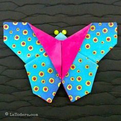 an origami butterfly with pink and blue wings