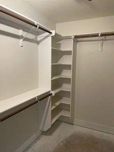 an empty walk in closet with white walls