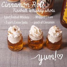 there are three jars with whipped cream and cinnamon roll shots in them on the table