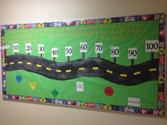 a bulletin board with numbers, roads and signs on it's side in a room