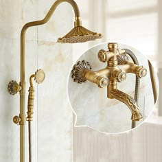 an old fashioned shower faucet with gold fixtures