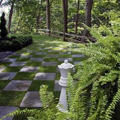 a white chess board in the middle of a garden