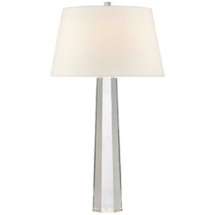 a table lamp with a white shade on the base and a light in front of it