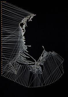 a wire sculpture is shown against a black background