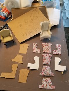 several pieces of paper are laid out on a table with scissors and other crafting supplies