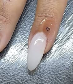 a woman's hand with a heart shaped manicure on her nails and the nail is