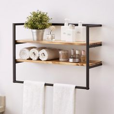 two shelves with towels, soaps and other items on them