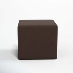 a brown cube sitting on top of a white floor