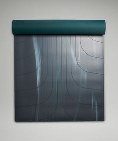 a green roller shade hanging on the side of a wall