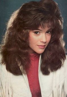 an autographed photo of a woman with long dark hair wearing a white shirt and red tie