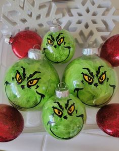 green ornaments with yellow eyes and grin face drawn on them