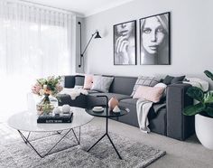 a living room filled with furniture and pictures on the wall above it's coffee table