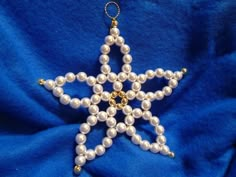 a white beaded star ornament on a blue background