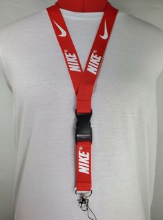 Nike Lanyard Red & White Strap Detachable Keychain Badge ID Holder Nike Red & White Detachable Lanyard and Metal Clasp. Take your game and your work to the next level with this stylish lanyard. The lanyard coloring is red and the logo coloring is white. The lanyard measures a total length of 22 inches (56cm) and a 1 inch (2.5cm) strap width comfortably fitting adults. It features a detachable plastic buckle clip and a metal clasp at the end of the strap which is great for keys, ID’s, badges, nam Red Lanyards With Key Leash For Gifts, Red Lanyard With Key Leash As Gift, Nike Keychain, Nike Lanyard, Nike Red, Id Holder, Lanyard, 1 Inch, Red White