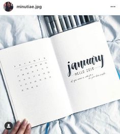 an open notebook with the word january written in cursive writing