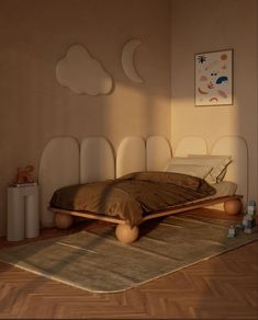 a bed sitting on top of a wooden floor next to a wall mounted art piece