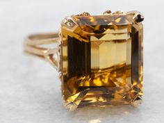 Transform your look with solitaire ring. The stunning emerald cut citrine stone set in yellow gold adds a touch of elegance and sophistication to any outfit. A perfect statement piece for any occasion. Metal: 14K Yellow Gold Gem: Citrine 9.11 Carats Gem Measurements: 11.8 x 13.1 mm, Emerald Cut Ring Size: 6.25 Marks: "14K" Stamped on the inside band SKU #: A40402 Each piece has been identified and graded by a Graduate Gemologist who has been certified by the Gemological Institute of America (GIA). We have six brick-and-mortar storefronts in Maine, Massachusetts, and New Hampshire and have been in business for over 25 years! Please visit our Shop's About Page or our website for more information about our jewelry. For questions about diamond grading, we recommend the  Gemological Institute o Yellow Topaz Ring, Dark Wedding Theme, Dinner Ring, Colored Stone Rings, Emerald Cut Rings, Citrine Ring, Citrine Stone, Gold Set, Topaz Ring