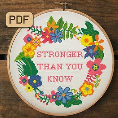 a cross stitch pattern with the words,'anarchy lies'and flowers on it