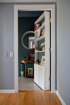 an open door leading to a room with blue walls