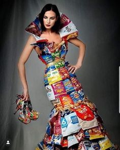 a woman in a dress made out of candy bars and chips is posing for the camera