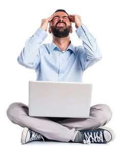 a man is sitting on the floor with his head in his hands and looking up