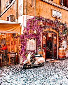 a scooter parked in front of a building with vines growing on it's side