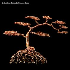 a wire tree sculpture sitting on top of a black surface with its roots growing out of it