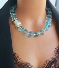 📍 Description :  The handmade necklace has been designed with A + high quality and rare find blue Topaz gemstone and A + quality genuine Baoque Pearl. 💥 The colours of the stone may differ slightly in photo shoots caused by lighting and reflections. The necklace is Modern chunky statement gemstone beaded asymetrical necklace for women. The necklace does not stretch and well kept its shape. ✂ Materials : The natural stones used is : AAA quality Blue Quartz The chain and gold-colored materials used are 14 carat gold plated on brass and do not tarnish. 📐 Dimensions : The necklace has a length of 42 centimeters/16 inç and can be adjusted using an extention cord. The weight of the necklace is 132 gr. 🧹 Care of the necklace: Although my products are durable and unlikely to tarnish, it is bet Anniversary Necklace, Necklace Big, Made Jewelry, Mother Birthday Gifts, Blue Quartz, Pearl Gemstone, Jewelry Wedding, Hand Made Jewelry, Topaz Gemstone