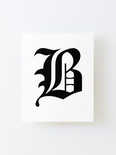 the letter b is made up of black and white letters on a square paper block