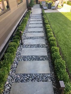 a stone path in front of a house