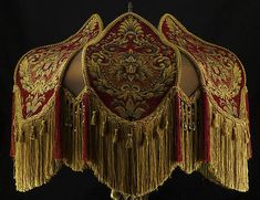 an elaborate gold and red chair with tassels